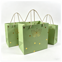 Hot Sell Custom Gold Foil Logo Black Matt Paper Bag With Ribbon Handles Shipping Packaging Bag