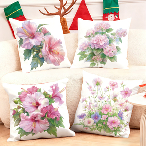 Floral throw pillows adorn cozy sofa with festive stockings and reindeer antlers in holiday decor scene - Product Image 1
