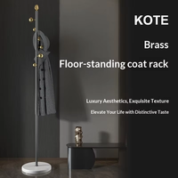 Porte-manteau rotatif en laiton de luxe léger et créatif, sur pied en marbre, pour salon, chambre et entrée