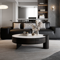 Table basse ronde moderne avec plateau en pierre frittée blanche et base de rangement en bois foncé