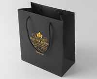 Sac en papier noir mat avec logo en feuille personnalisée laminée de luxe Sac en papier moderne en or rose de qualité supérieure avec poignée 380 400 g/m²