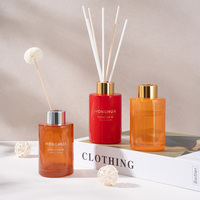 Vente en gros de flacons ronds en verre de 100 ml pour parfum d'ambiance avec bâtonnet en bois et bouchon de couleur rouge-orange