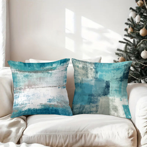 Абстрактные бирюзовые декоративные подушки украшают уютную гостиную, дополненные праздничными носочками и декором в виде оленьих рогов. - Product Image 3