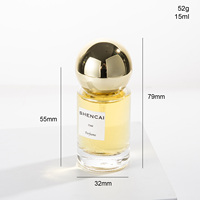 Flacon de parfum en verre transparent cylindrique de 15 ml, format voyage, avec vaporisateur et capuchon rond, pour parfum de luxe.