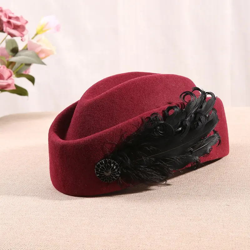 秋と冬の英国のレトロなスチュワーデスベレー小さなギフト帽子韓国の女性の羽の装飾ベレーウール帽子
