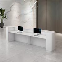 Dongguan Table de réception pour chambre d'hôtel Table de réception de vente au détail à LED Table de réception géométrique en forme de L Bureau de réception blanc