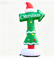 Panneau directionnel de Noël gonflable avec logo, flèche rouge et verte indiquant l'atelier du Père Noël pour la signalisation des centres commerciaux et des événements