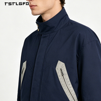 Veste utilitaire en toile bleu marine personnalisée, col montant, fermeture éclair intégrale, poches doubles sur la poitrine, poignets ajustables à l'avant, unisexe