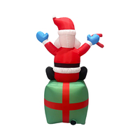 Père Noël gonflable de 6 pieds assis sur une boîte cadeau avec une canne en sucre pour la décoration de jardin, de cour ou de fête en extérieur