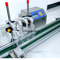 Machine de remplissage avec quatre buses pour gin, vodka, et équipement de remplissage de bouteilles en verre à petite échelle pour spiritueux/alcool, whisky