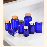 60ml 75ml 100 ml 120ml 150ml 200ml 250ml 300ml 400ml 500ml ml Emballage de bouteille capsule en verre ronde bleu cobalt avec bouchon en bambou