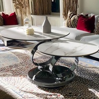 Meubles de maison d'hôtes modernes Cadre en acier inoxydable argenté rotatif Plateau rond en pierre frittée blanche Table basse