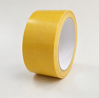 Ruban adhésif double face en tissu jaune à haute adhérence, sans résidu, pour la fixation de tapis et moquettes d'exposition