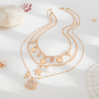 Collier pour femme en or 14 carats, style bohème, multi-couches, avec pendentifs étoile de mer, coquillage, conque et perles d'imitation, chaîne de clavicule haut de gamme