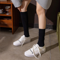 Vente en gros de chaussettes en coton pour mollet personnalisées Chaussettes demi-jambe de couleur unie Chaussettes de compression noires hautes jambes minces