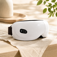 Masque de massage oculaire avec compression d'air, compresse chaude, vibration et musique, appareil de soin des yeux rechargeable blanc