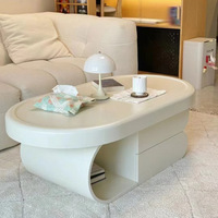 Grande table basse polyvalente de style crémeux à texture haut de gamme pour tout salon Rangement de forme ovale pour appartement de petite taille