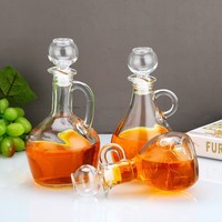 Bouteilles en verre transparentes en stock, design moderne et minimaliste, poignée sculptée en forme de fleur pour cuisine ; bidon à huile, bouteille de vin