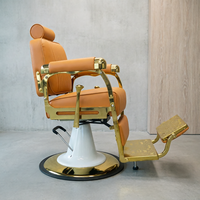 Fauteuil de barbier de luxe avec cadre plaqué or, revêtement en cuir PU orange-brun, appui-tête réglable, inclinable, équipement de salon de coiffure