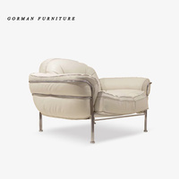 Fauteuil de loisirs Gorman en cuir de style luxueux avec coussin confortable en éponge et structure en acier inoxydable, canapé individuel avec ottoman