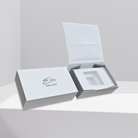 Boîte en carton rigide blanche de luxe avec logo argenté en forme de livre Coffrets cadeaux magnétiques pliants Insert en mousse EVA Stratification mate de crème pour le visage