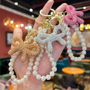 Llavero <span class=keywords><strong>de</strong></span> lazo con diamantes <span class=keywords><strong>de</strong></span> imitación <span class=keywords><strong>de</strong></span> moda al por mayor, colgante <span class=keywords><strong>de</strong></span> cadena <span class=keywords><strong>de</strong></span> perlas estilo coreano inspirado en Chanel para mujer - Product Image 3