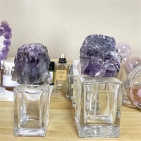 Flacon de parfum rond en verre de luxe avec couvercle en marbre coloré, fond de montagne, flacon de parfum unique