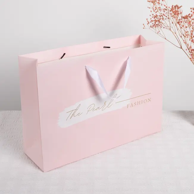 Sacchetto di carta stampato in oro rosa borsa personalizzata per imballaggio di gioielli boutique sacchetti regalo di carta per lo shopping con manici a nastro