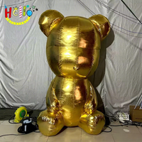 Sculpture géante gonflable en or métallique d'un ours assis, accessoire décoratif pour centre commercial de luxe