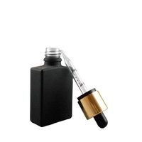 Flacon d'huile essentielle en verre rectangulaire noir mat de 30 ml avec bouchon anti-effraction doré pour enfant