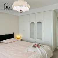 Armoire moderne blanche de style européen XINGRUO avec portes en verre cannelé cintrées, poignées dorées, tiroirs pleine hauteur, intégrée pour chambre à coucher