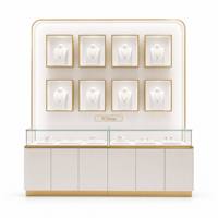 Vitrine de présentation de bijoux haut de gamme avec finition or brossé, vitrine murale blanche avec éclairage LED intégré pour magasin de bijoux
