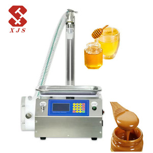Machine de remplissage automatique de liquides (miel, huile comestible, pâte) en bouteilles avec <span class=keywords><strong>pompe</strong></span> à engrenages et pesage manuel - Product Image 1