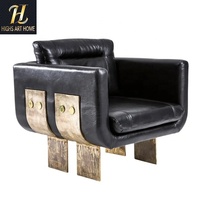 Fauteuil de salon sur mesure haut de gamme en cuir noir avec accent en métal liquide pour hôtel, villa, salon
