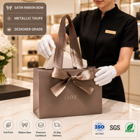 Sac fourre-tout personnalisé en satin gris-beige avec nœud, poignées en cordon et finition métallique, emballage cadeau en papier ivoire pour boutique, idéal pour les fêtes et magasins, MOQ 500 pièces