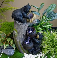 Deux sculptures d'ours noirs en résine avec fontaine à eau et lumières LED pour la décoration de jardin