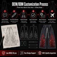 Pantalon de survêtement streetwear personnalisé avec logo, effet délavé, coupe oversize, strass, jambes évasées et superposées, imprimé flamme et broderie