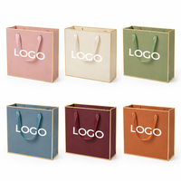 Customized Clothing Brand Packaging Paper Bag 250g Paperboard Colours Paper Bag with Ribbon Handles