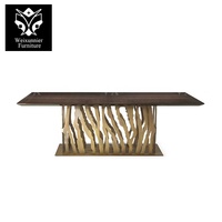 Table à manger élégante de luxe 6 places avec dessus en marbre et socle évidé en acier inoxydable meubles de salle à manger