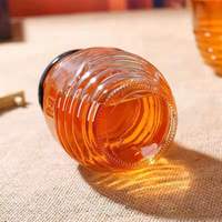 Pot de miel de bouteille en verre en gros pour le stockage des aliments pot en nid d'abeille 120g 250g 500g 1000g avec couvercle