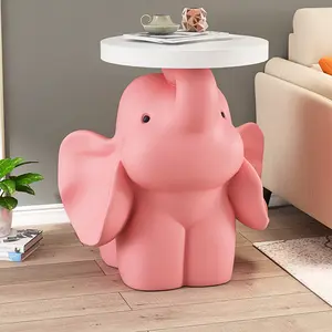 A large elephant has a home ornament on the ground