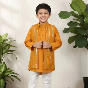 Niño sonriente con kurta naranja tradicional y pantalones blancos, posando en interiores, ropa étnica festiva, retrato de niño feliz - Product Image 1