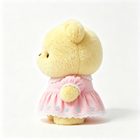 Ours en peluche compact Kawaii avec tenue à volants et imprimé floral, texture douce et bouclée, jouet en peluche animal en peluche