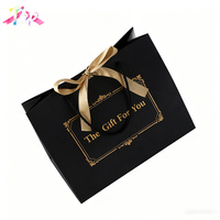 Sac cadeau de luxe en papier noir mat avec logo de votre marque imprimé sur mesure, estampage à chaud doré, poignées en coton et ruban, pour vêtements