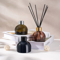 Vente en gros de flacons ronds en verre de 100 ml pour l'emballage d'huiles essentielles d'aromathérapie avec bâtonnets diffuseurs