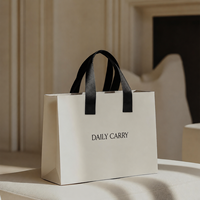 Sacs shopping en papier noir mat de luxe personnalisés avec logo et poignées en ruban noir pour emballage de boutique haut de gamme