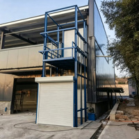 Plateforme élévatrice verticale fixe pour marchandises avec rail de guidage hydraulique et dispositif de protection de sécurité