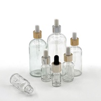 Flacon compte-gouttes en verre vide avec col fileté, collier doré et insert à bille blanche pour emballage cosmétique d'huiles essentielles et de sérums