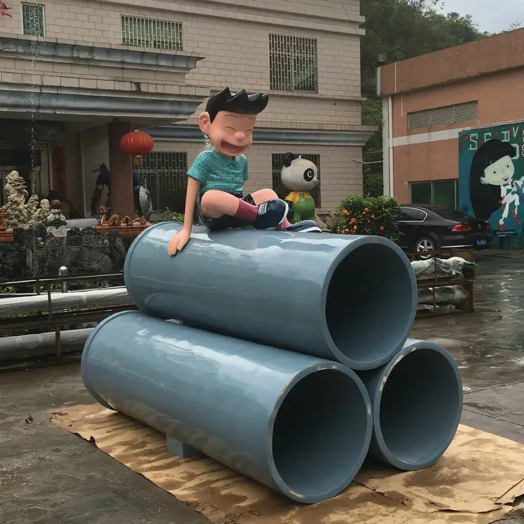 Fiberglass big tube with boy character sculpture