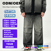 Pantalon cargo large pour homme, gris vert délavé, coupe ample, cordon de serrage à l'ourlet, poches à rabat arrière, boutons-pression, style utilitaire